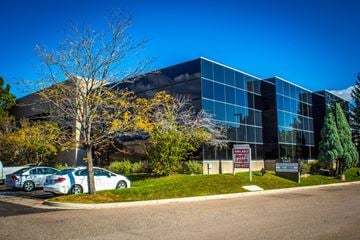 Colorado Springs apartment for rent - A modern building with a parking lot in front.