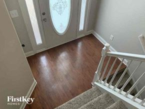 Bethlehem house for rent - a hallway with stairs and a door with wood floors