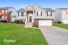 Clarksville house for rent - A house with a brick front and a garage door.