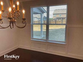 Lithia Springs house for rent - a dining room with a large window and a chandelier