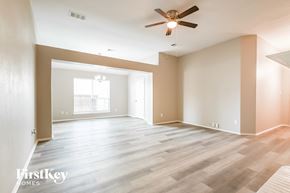 Forney house for rent - a living room with wood floors and a ceiling fan