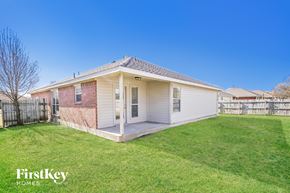 Forney house for rent - a small white house with a grass yard and a fence