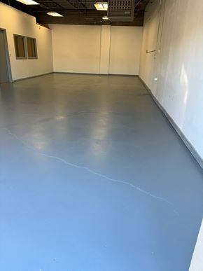 Tulsa apartment for rent - A large empty room with a grey floor and white walls.