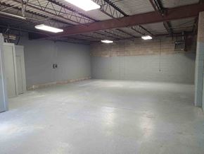 Tulsa apartment for rent - A large, empty room with a concrete floor and a metal roof.