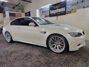 Tulsa apartment for rent - A white BMW car is parked in a garage.