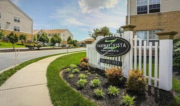 Frederick apartment for rent - a neighborhood sign in front of a white fence