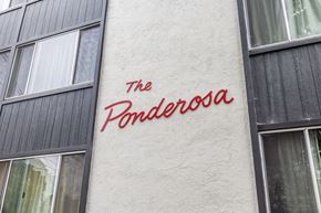 Oakland apartment for rent - The Penderosa sign is on a white wall.