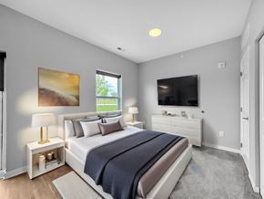 Pleasant Hill apartment for rent - A bedroom with a large bed, a television, and a painting on the wall.