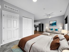 Pleasant Hill apartment for rent - A bedroom with a large bed and a ceiling fan.