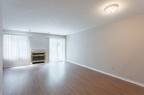Ottawa apartment for rent - an empty living room with a fireplace and wood flooring
