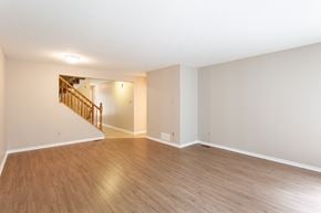 Ottawa apartment for rent - an empty living room with wood flooring and a staircase