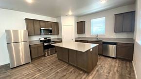 Forest Grove house for rent - an empty kitchen with stainless steel appliances and wooden floors