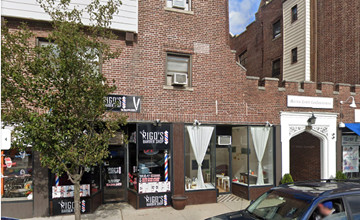 Harrison apartment for rent - a store front of a brick building on a city street