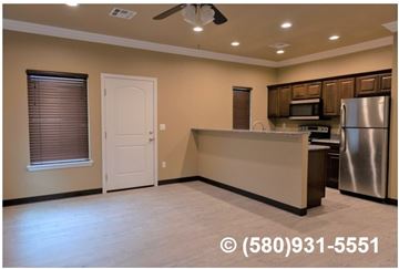 Durant apartment for rent - A kitchen with a refrigerator, microwave, and oven.