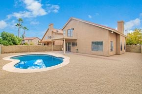 Gilbert house for rent - a pool in the backyard of a house with a patio
