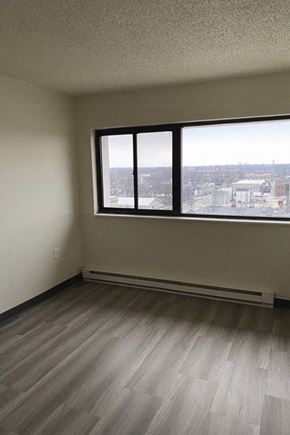 Kokomo apartment for rent - an empty room with three windows and a wooden floor