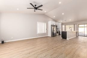 Glendale house for rent - A spacious room with a ceiling fan and wooden flooring.