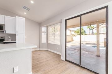Glendale house for rent - A kitchen with white cabinets and a countertop with a microwave and oven.