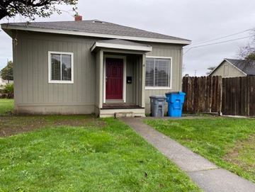 Eureka apartment for rent - A small house with a red door and a blue trash can.