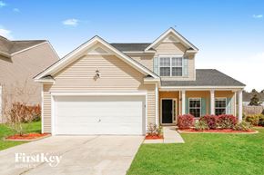 Moncks Corner house for rent - a beige house with a white garage door