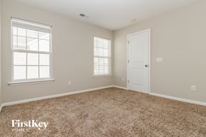 Moncks Corner house for rent - a bedroom with carpet and a door and two windows