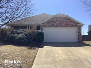 Waxahachie house for rent - a brick house with a white garage door