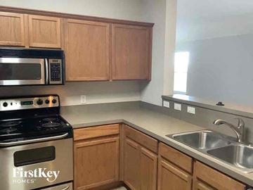 Waxahachie house for rent - a kitchen with a sink and a stove and a microwave