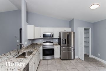 Palm Bay house for rent - a kitchen with granite counter tops and stainless steel appliances