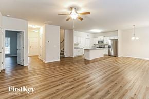 High Point house for rent - A spacious kitchen and living room with wooden floors and white walls.
