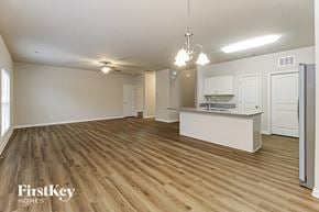 High Point house for rent - A spacious kitchen and living room with wooden floors and white walls.
