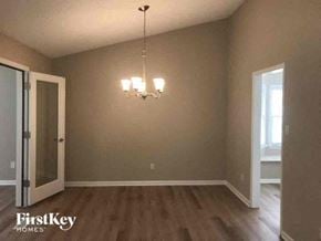 Gastonia house for rent - a empty living room with a chandelier and a door