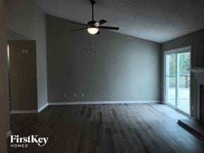 Gastonia house for rent - an empty living room with a ceiling fan