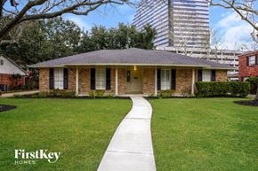 Houston house for rent - a small brick house with a sidewalk leading to the front door