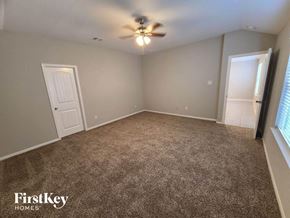 Katy house for rent - an empty living room with a ceiling fan