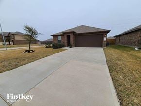 Katy house for rent - a concrete sidewalk in front of a house