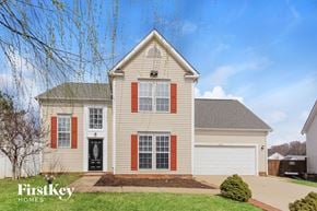 Charlotte house for rent - a white house with red shutters and a driveway