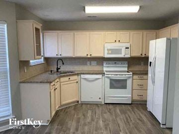 Charlotte house for rent - a kitchen with white appliances and white cabinets
