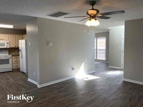 Charlotte house for rent - an empty living room with a ceiling fan
