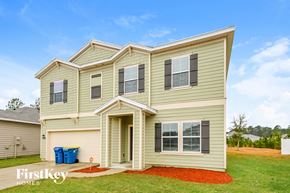 Jacksonville house for rent - a home with tan siding and a gravel driveway