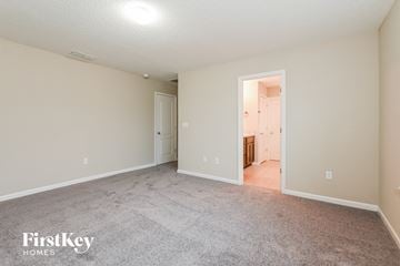 Jacksonville house for rent - a spacious living room with carpet and a door to the kitchen