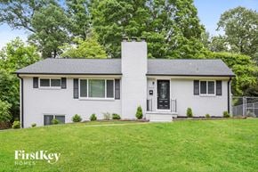 Winston Salem house for rent - a white house with black shutters and a green lawn