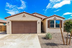 Surprise house for rent - A house with a brown garage door is for sale.