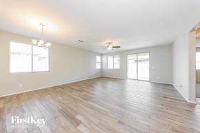 Surprise house for rent - A spacious room with wooden flooring and a ceiling fan.