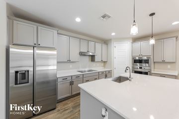 Surprise house for rent - A modern kitchen with a stainless steel refrigerator and white countertops.
