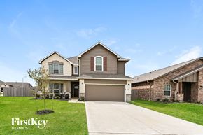 Baytown house for rent - a house with a driveway and a garage door