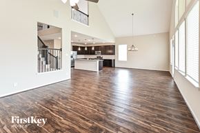 Baytown house for rent - an open living room and kitchen with wood flooring