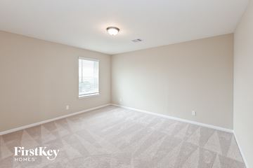 Baytown house for rent - the spacious living room with white carpet and a window