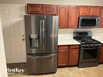 Plainfield house for rent - a kitchen with a large stainless steel refrigerator