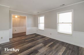 Lewisville house for rent - A room with wooden floors and two windows.