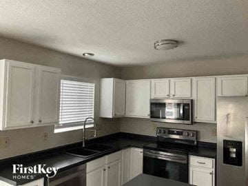 Reynoldsburg house for rent - a kitchen with a stove and a microwave